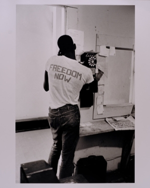A Black activist talks on a pay phone during Freedom Summer.