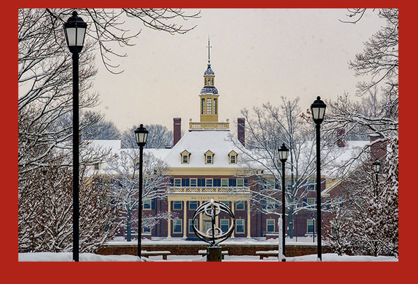  MacCracken Hall framed by snow covered trees with the sundial in the foreground