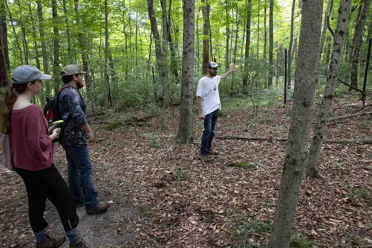 Dave Gorchov and 2 students walk down a trail in the natural areas