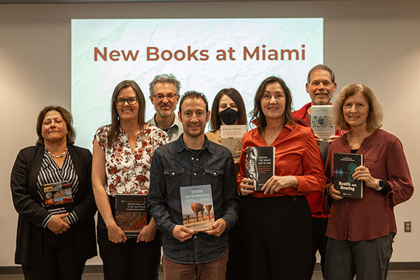 Several faculty members pose with their books published this year