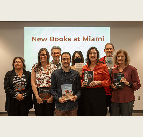 Several faculty members pose with their books published this year