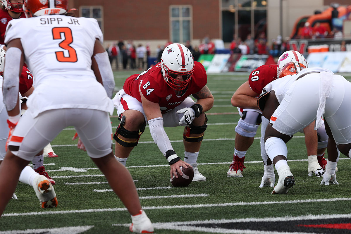 Miami's Kolby Borders (64) prepares to hike the football