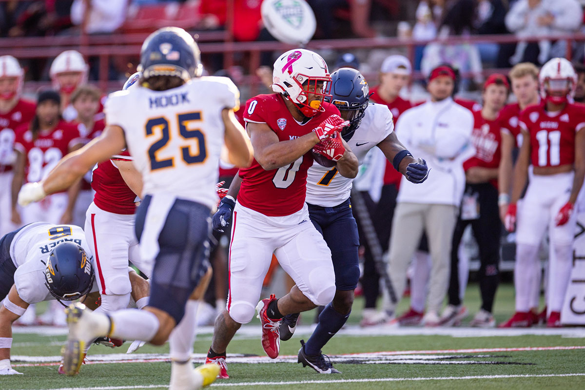 Miami's Rashad Amos (0) runs with the football