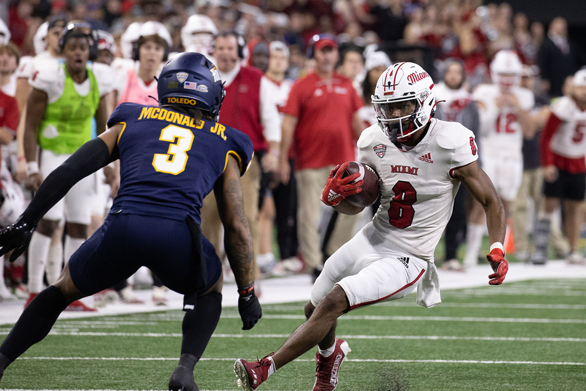 Miami's Kevin Davis runs the football