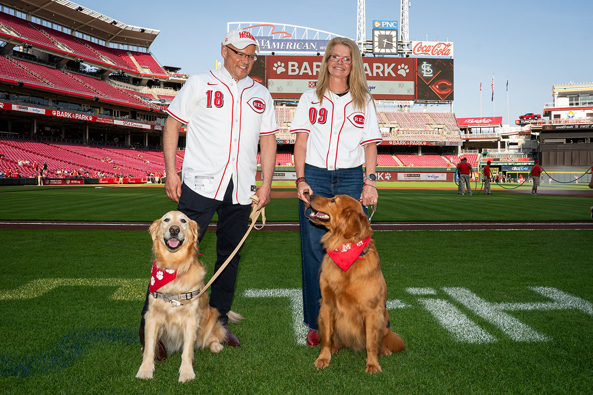 Miami University President Gregory Crawford and University Ambassador Dr. Renate Crawford with their dogs, Ivy and Newton, at Great American Ball Park
