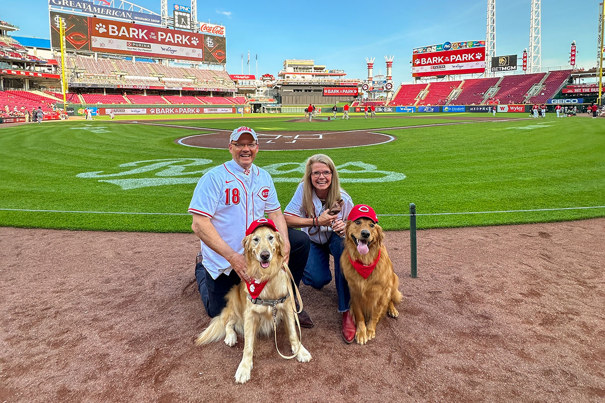 Miami University President Gregory Crawford and University Ambassador Dr. Renate Crawford with their dogs, Ivy and Newton, at Great American Ball Park