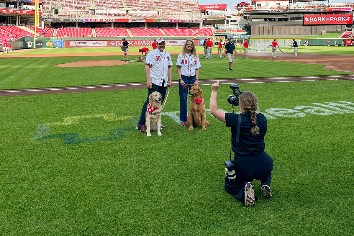 Miami University President Gregory Crawford and University Ambassador Dr. Renate Crawford with their dogs, Ivy and Newton, at Great American Ball Park