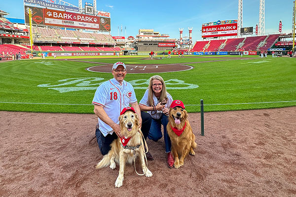 Miami University President Gregory Crawford and University Ambassador Dr. Renate Crawford with their dogs, Ivy and Newton, at Great American Ball Park
