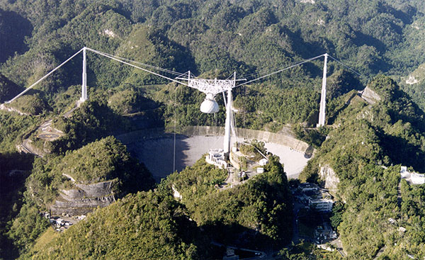 Qihou Zhou (shown here in 1993) was a research scientist at Arecibo Observatory from 1991-2002. He is standing on the catwalk to the telescope, which was one way to access the instrument platform.