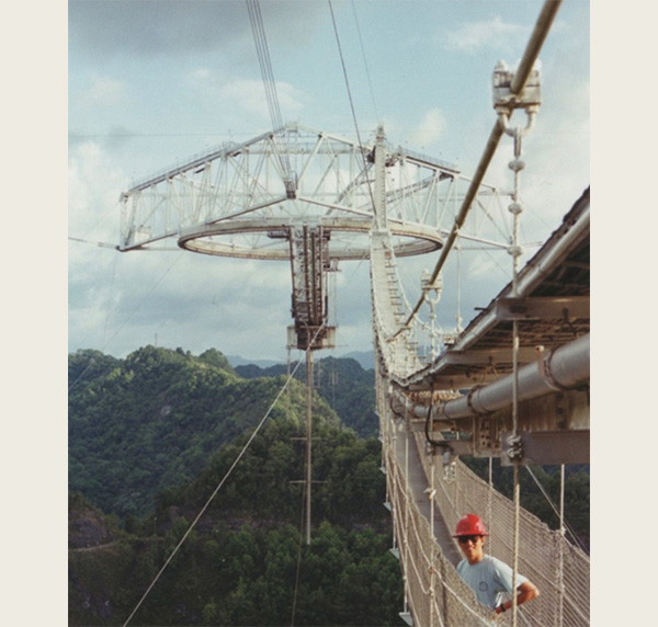 Qihou Zhou (shown here in 1993) was a research scientist at Arecibo Observatory from 1991-2002. He is standing on the catwalk to the telescope, which was one way to access the instrument platform.