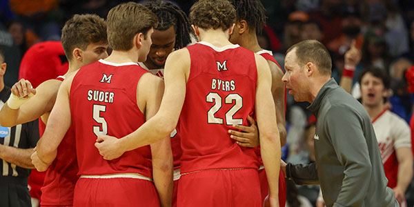 Travis Steele, right, with Miami men's basketball team