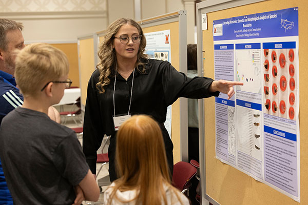 Emma Fischels presents her research to a group of visitors at the forum